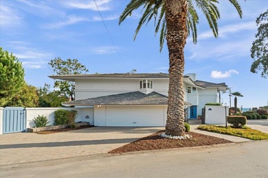 Perched on a spacious corner lot steps from beach access-this