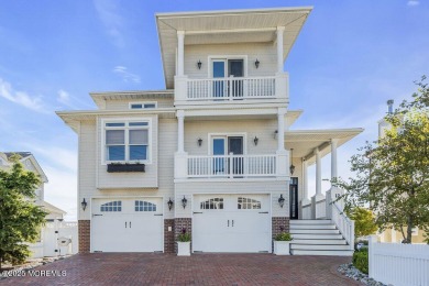 Welcome to your dream home on the bay! This stunning custom
