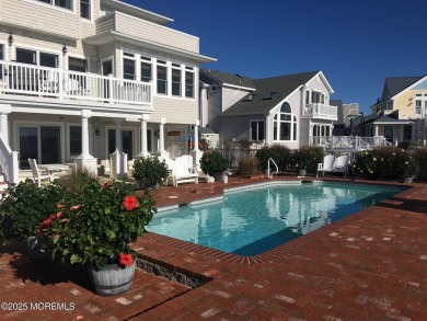 Welcome to your dream home on the bay! This stunning custom