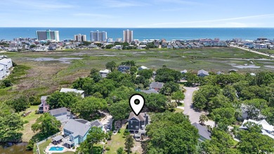 This spacious five-bedroom, four-bathroom raised beach home is