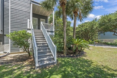 This spacious five-bedroom, four-bathroom raised beach home is