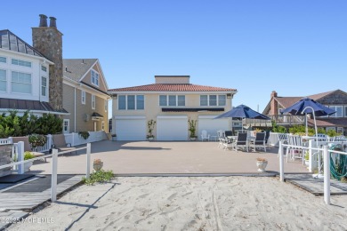 Beautiful Ocean Front Home sits gracefully on a pristine white