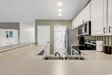 Spacious third-floor two-bedroom, two-bath condo located in an