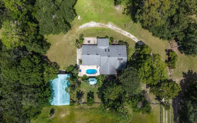 Welcome to this beautiful 5.17-acre gated property, perfectly