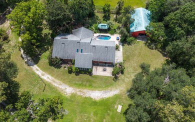 Welcome to this beautiful 5.17-acre gated property, perfectly