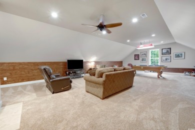 Nestled on a serene 1.88 acre wooded lot, enjoy resort-style