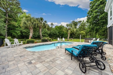 Nestled on a serene 1.88 acre wooded lot, enjoy resort-style
