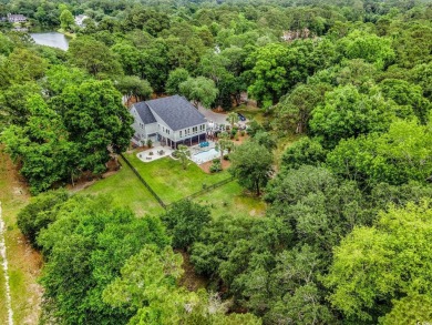 Nestled on a serene 1.88 acre wooded lot, enjoy resort-style