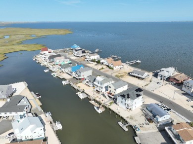 Wake to soft morning light dancing across the bay and end each