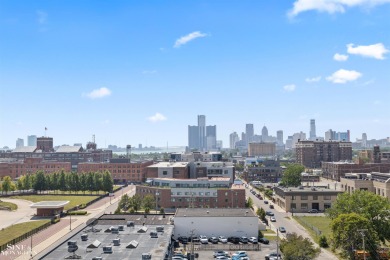 Wake up to sweeping views of the Detroit River and downtown