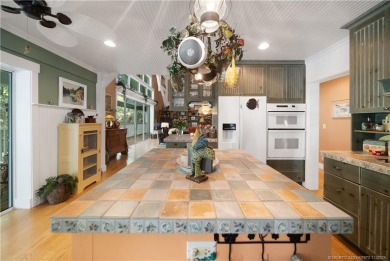 Attention car collectors!!! This unique lushly landscaped 3