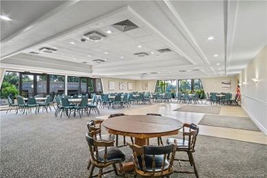 Enjoy the ease of Florida living in this first floor, end unit