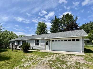 Easy living in the 2 Lake town of Onekama. Home sits on a street