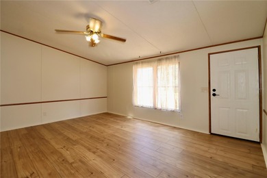 Tucked away on a quiet street sits this cozy half acre lot with