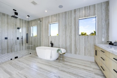 This extraordinary new-construction waterfront estate offers a