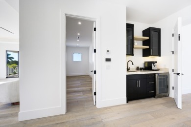 This extraordinary new-construction waterfront estate offers a