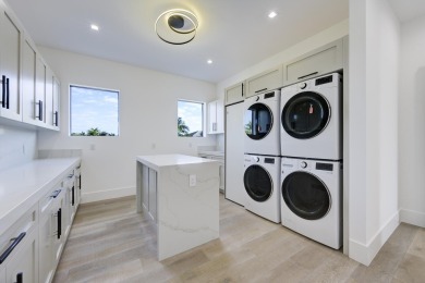 This extraordinary new-construction waterfront estate offers a