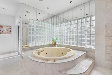 Positioned within the exclusive, guard-gated community of Bay