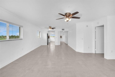 SS appliances, white cabinets, mottled brown granite counters &