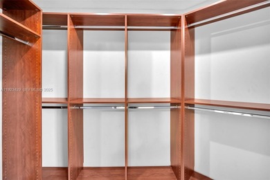 SS appliances, white cabinets, mottled brown granite counters &