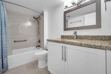 SS appliances, white cabinets, mottled brown granite counters &