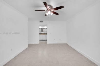 SS appliances, white cabinets, mottled brown granite counters &