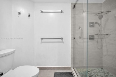 SS appliances, white cabinets, mottled brown granite counters &