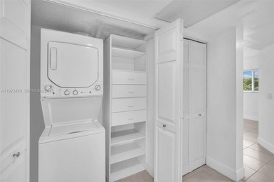 SS appliances, white cabinets, mottled brown granite counters &