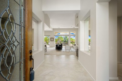 The beautifully relandscaped front yard with faux grass, exotic