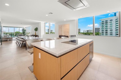 Step into this stunning corner unit at Onda, Bay Harbor's