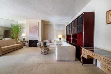 Perched above the shimmering lake and emerald fairways, 899