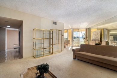 Perched above the shimmering lake and emerald fairways, 899