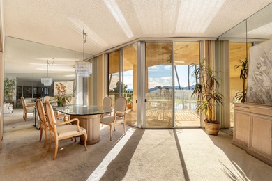 Perched above the shimmering lake and emerald fairways, 899