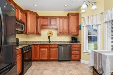 Embrace maintenance-free living in this beautiful end-unit