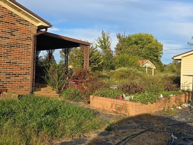 Bring your imagination! This 4-bedroom, 1.5-bath brick home is