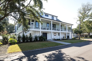 This gorgeous home in Kure Beach Village has 5 bedrooms, 5 1/2