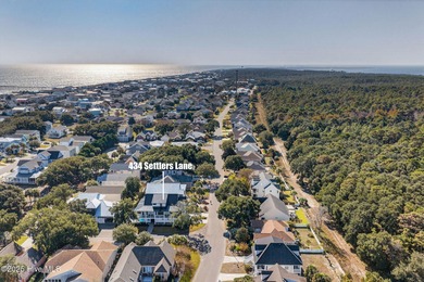 This gorgeous home in Kure Beach Village has 5 bedrooms, 5 1/2