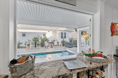 This gorgeous home in Kure Beach Village has 5 bedrooms, 5 1/2