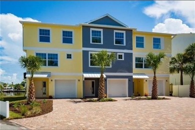 Stunning waterfront townhome just steps from the beach! Built in