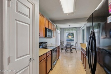 Welcome to this charming ground-level, end unit condo in the