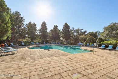 Welcome to this charming ground-level, end unit condo in the