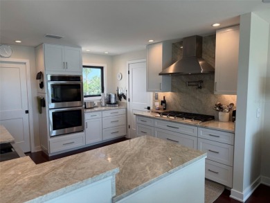 This exquisite custom waterfront residence features four