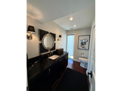 This exquisite custom waterfront residence features four