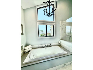 This exquisite custom waterfront residence features four