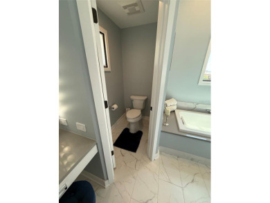 This exquisite custom waterfront residence features four