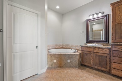 Enjoy tranquil golf course living and sweeping views from this