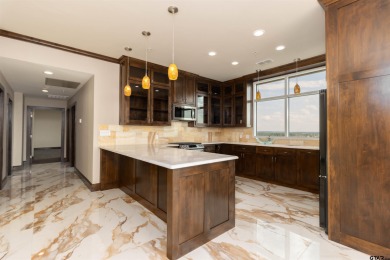 Experience luxury high-rise living in this stunning 4-bedroom