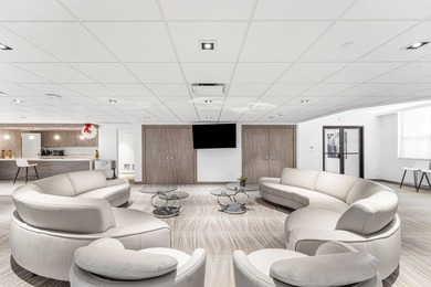 This unique first-floor condominium offers the scale and