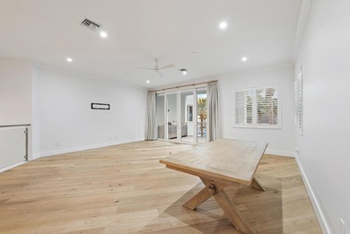 An elevated expression of coastal living, this three-story Water