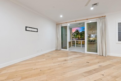 An elevated expression of coastal living, this three-story Water